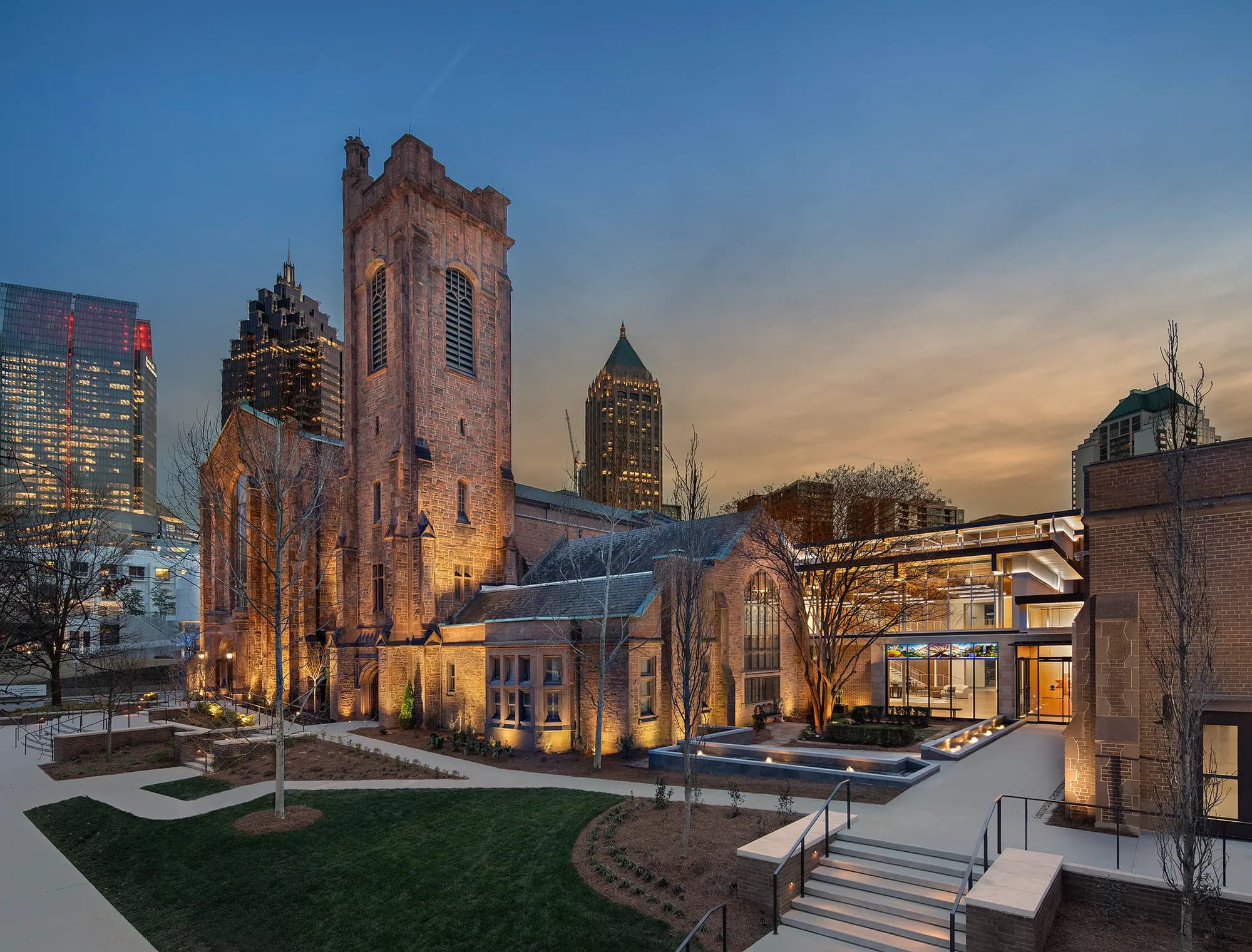 First Presbyterian Church in Atlanta with its stone tower and arched windows illuminated at dusk